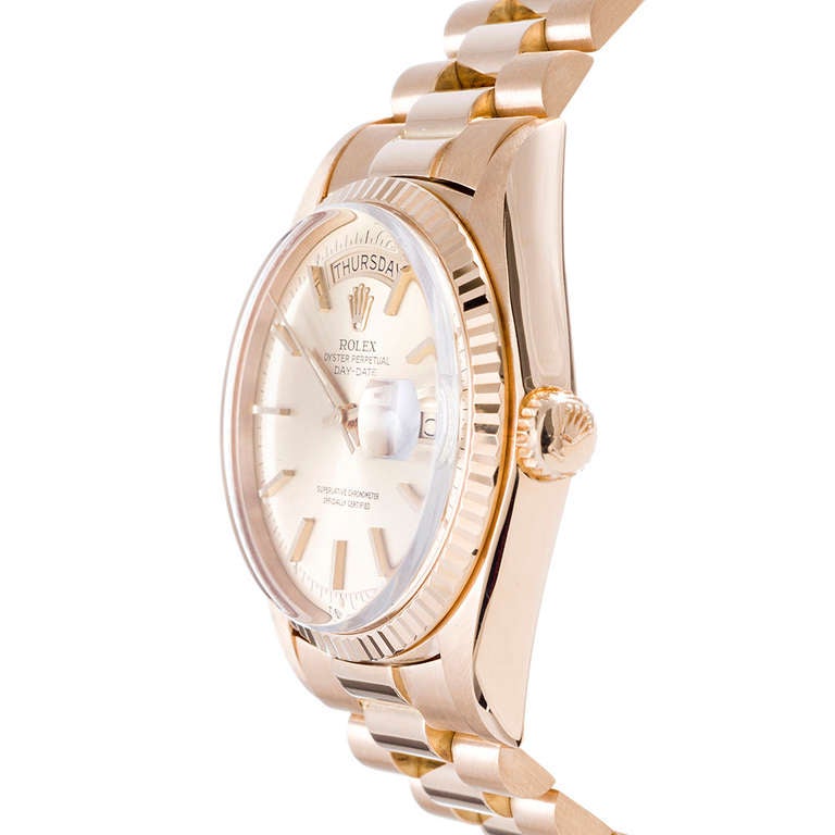This watch is impossible to find in such nice condition and is the most classic version of the Rolex Oyster Perpetual Day-Date wristwatch. This has a difficult-to-find original early hidden-clasp President bracelet, champagne index pie-pan dial and
