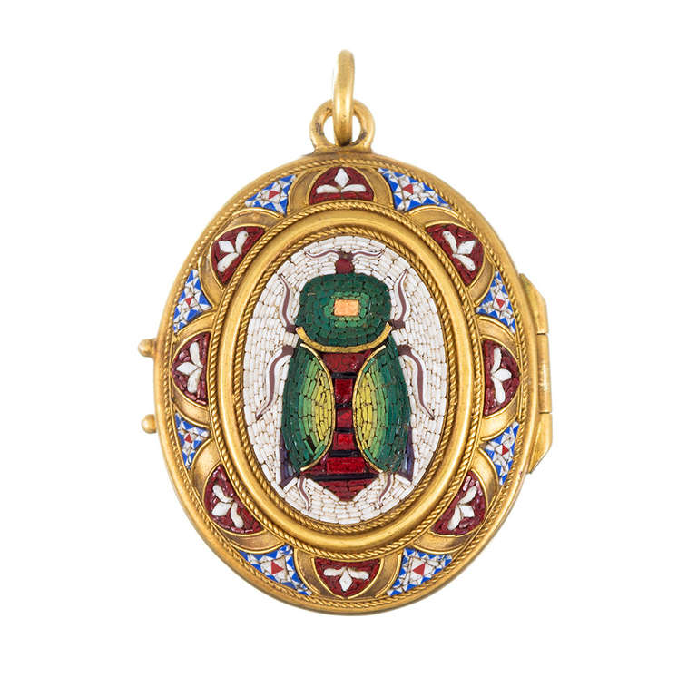 An absolutely exquisite rendering of micro mosaic, with detailed granulation, made of 18 karat yellow gold. The theme on the front is a scarab beetle in an ornate frame, with a highly-ornamented golden back, baring an inscription of the word 