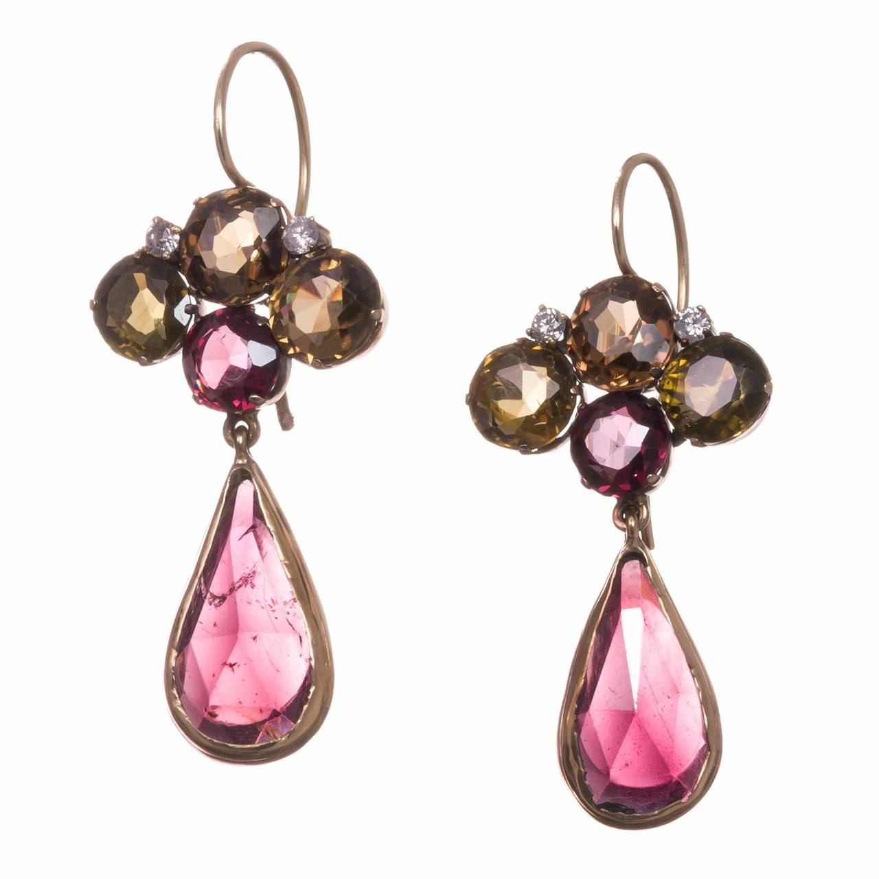 Substantial antique earrings, made of natural color zircons, garnets and diamonds, set in 14k yellow gold. These are from the Arts & Crafts period, made in the US circa 1915. The organic charm of this pair is evident, yet they also possess a subtle