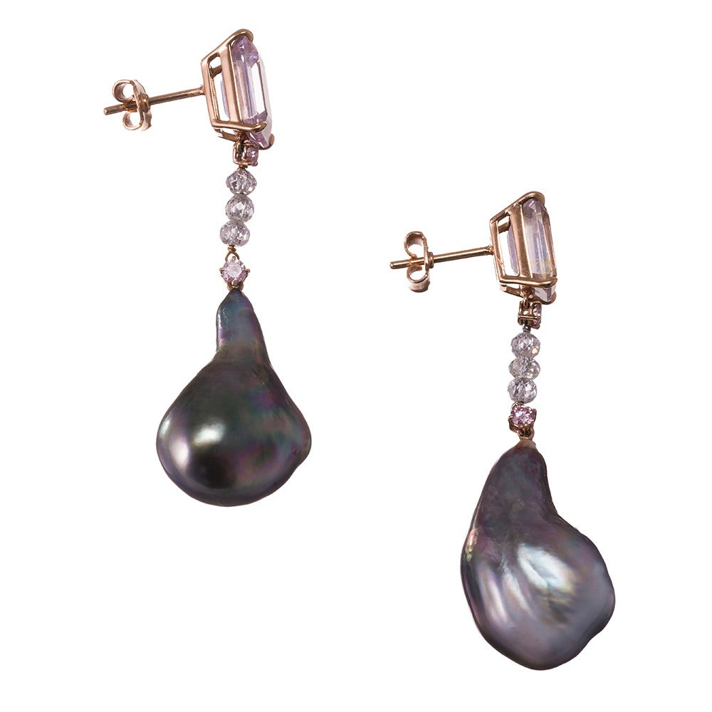 Two inch long drop earrings, boasting an unusual combination of gemstones: a 13 to 14mm Tahitian Baroque pearl, suspended from 2.50 carats of faceted diamond beads and accented with .12 carats of pink diamonds. The “cherry on top” is a pair of light