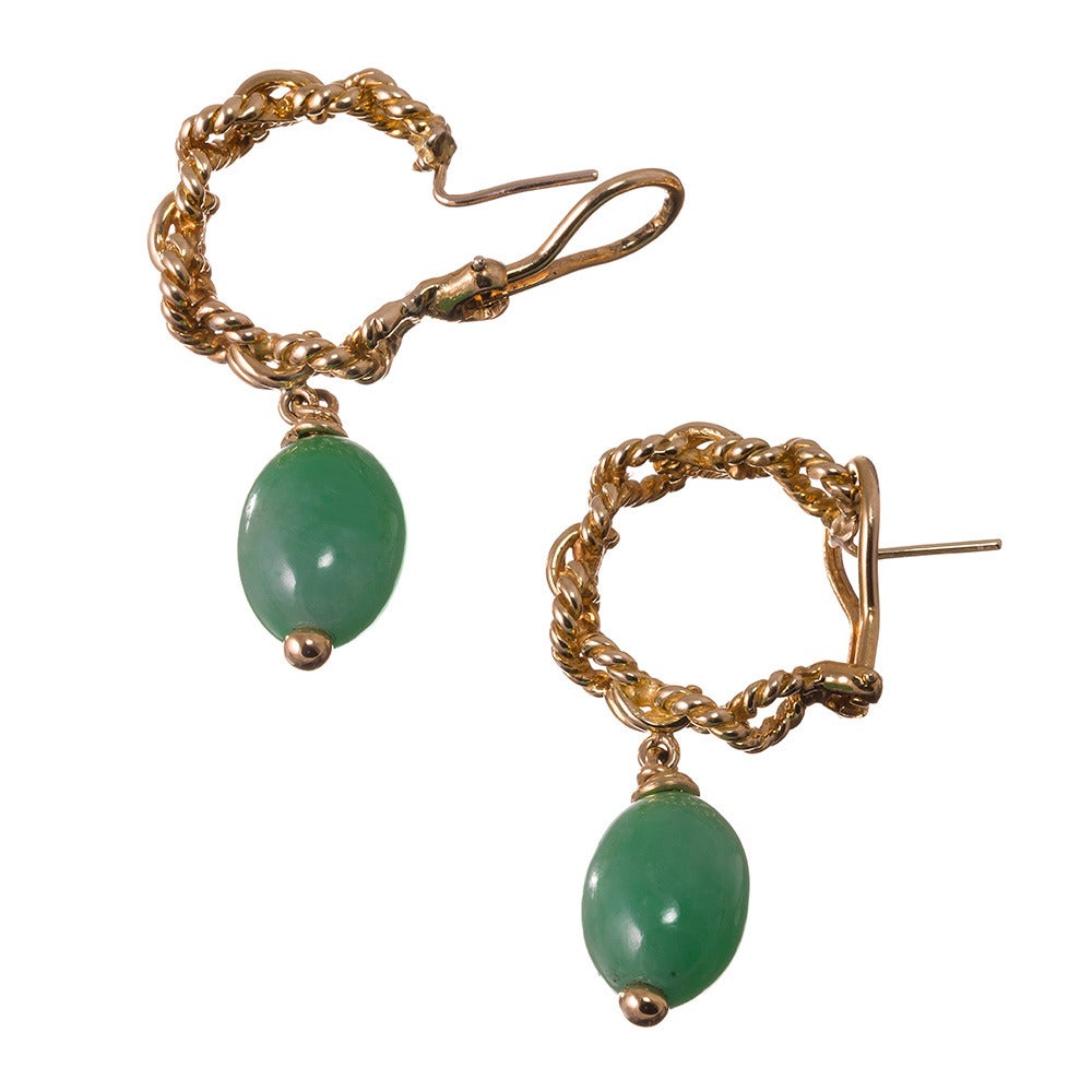 Twisted golden figure eights connected by double-row high polished links an oval pendant of jade suspended from each hoop, all compliments of Tiffany & Co. 1.75 inches in overall length. Currently pierced, these could easily be modified to clips.