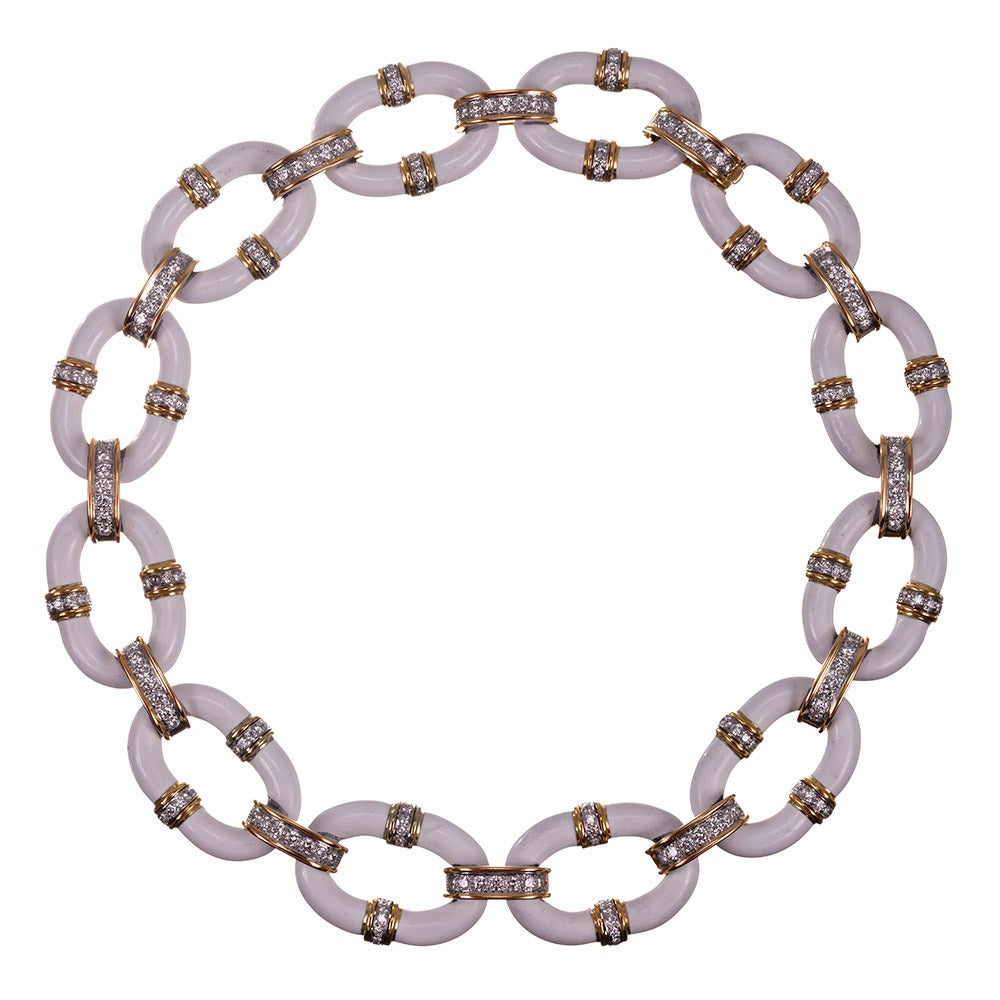 Twelve 1.25 inch long white enamel links are fashioned together by diamond bridges to form an infinite circle of crisp, chic brilliance. Wear this for drama or wear this for fun. The necklace measures 15 inches in overall length and contains