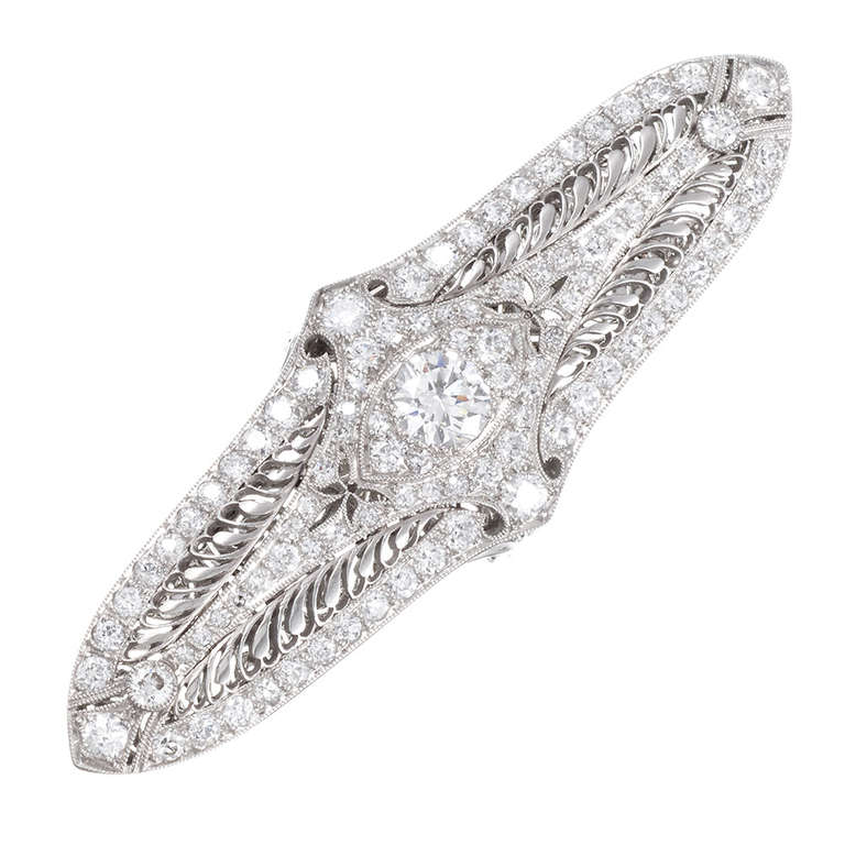 A super-creative way to repurpose a classic deco bar pin into a
fashion-forward accessory. This platinum bar pin is appointed with a 1.00
carat diamond center and further decorated with 2.85 carats of brilliant
diamonds, gorgeous open wirework,