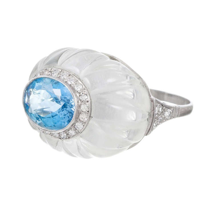 Rising an impressive 20 millimeters off the finger, this ring is guaranteed to garner some compliments. The unique and very symbiotic combination of color and texture from the carved rock crystal, aquamarine and diamonds offer a soft look, with the