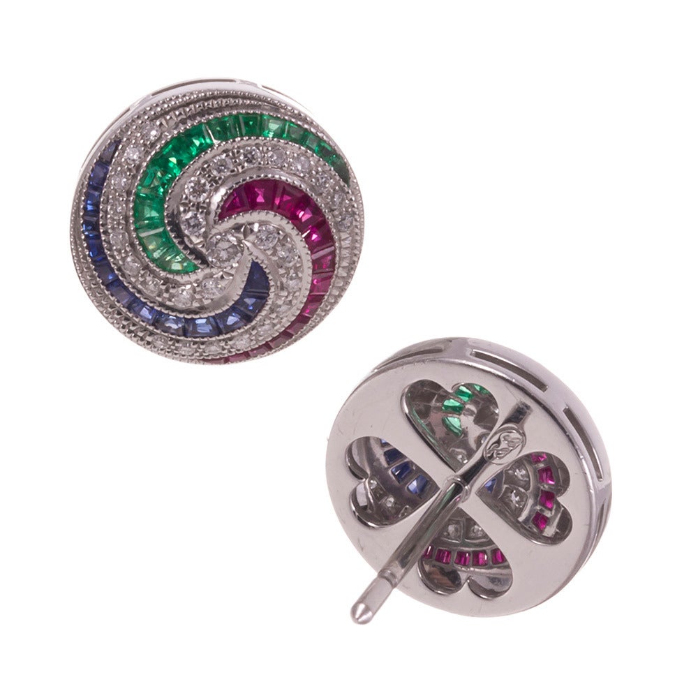 18k white gold earrings, festive pinwheel design of the finest gemstones, bordered in mil grain, in classic Lucie Campbell style. The earrings measure about a half inch in diameter, yet make quite an impact for their modest size. They are a bit