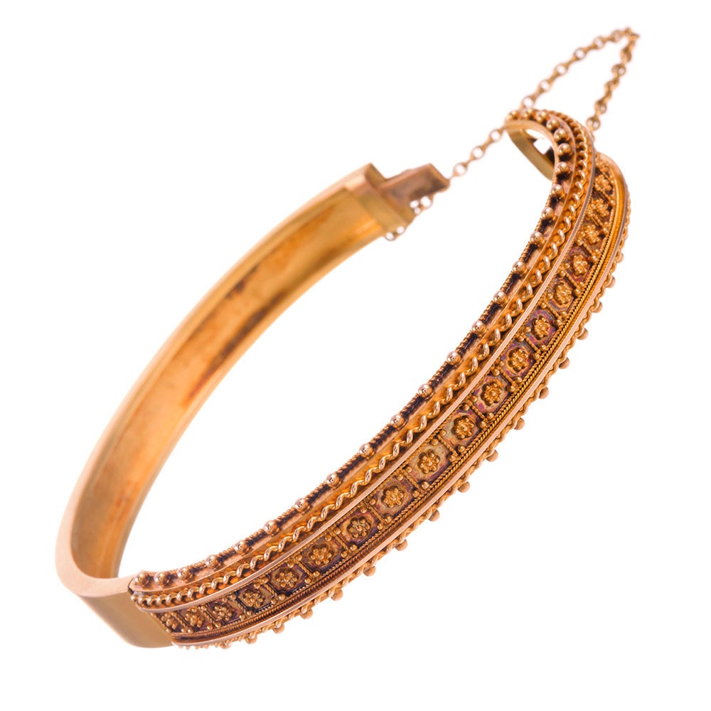 15k yellow gold bangle, classic oval design and ideal for “stacking” together with your other favorites. Single hinge design with a safety chain. The top is heavily decorated with ultra-fine granulation, creating a gorgeous jewel, despite the