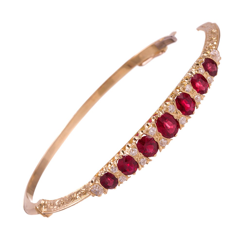 Inspired by the classic Victorian English carved style bangles of the late 19th century, set with the integrity of a new piece of jewelry. Made in the United Kingdom of 18k yellow gold and set with 3.80 carats of rubies and .60 carats of old