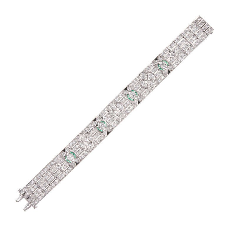 Impressive and very fine art deco bracelet, rendered in platinum, and boasting a lovely art deco design. Twelve marquis diamonds, set in three clusters, weigh 3.50 carats combined. An additional 10.50 carats of round diamonds have been set in