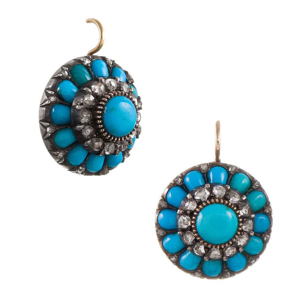 Exceptional quality Victorian earrings, made of rose gold and silver, and set with turquoise cabochons and rose cut diamonds, in a multi-layered cluster design. The turquoise exhibits beautiful color and even the rose cuts are of superior quality.