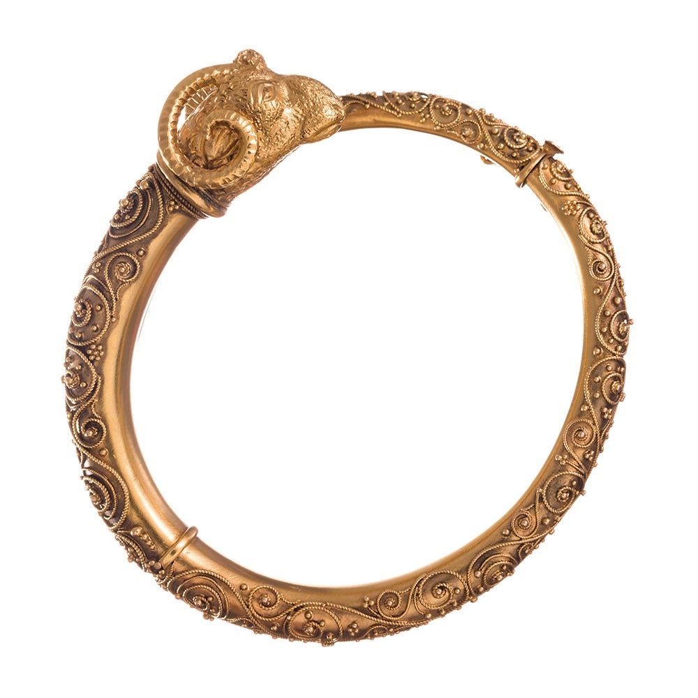 15k yellow gold bangle bracelet, extensive and very fine scrolling granulation, topped with a ram’s head motif. This super-fine detail is a hallmark of Etruscan jewelry and adds an enormous amount of interest, despite the absence of diamonds.