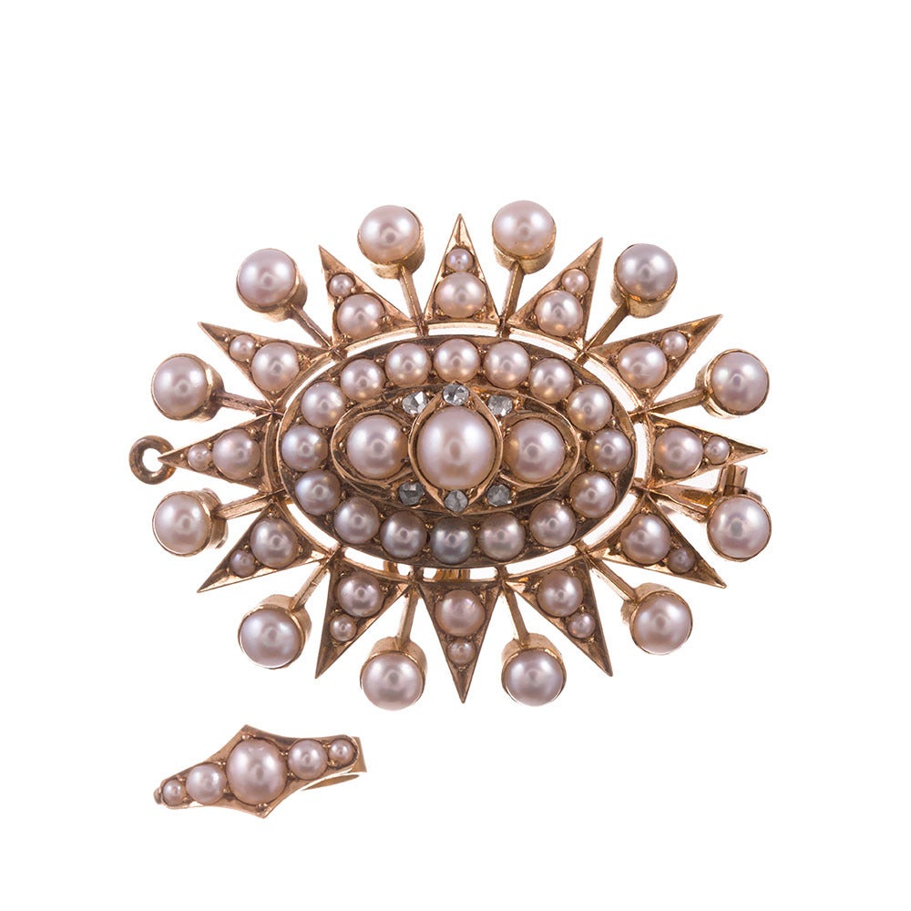 18k yellow gold pin/pendant, starburst design that is raised at the center, decorated with layers of lustrous pearls and accented with rose cut diamonds. The pin back can be unscrewed and removed, as well as the pearl-set bale can be removed and the