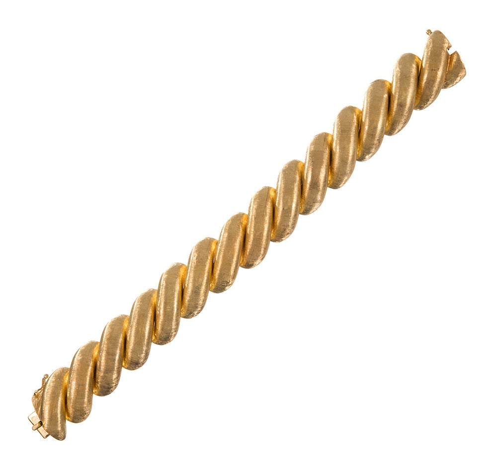 Offering an unbelievably fine hand, this sensual bracelet encircles the wrist with a never-ending coil of twisted golden rope. Textured in a fashion that only Buccellati can achieve and remaining in impeccable estate condition, complete with the
