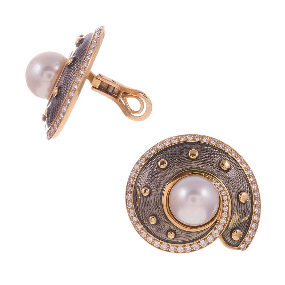 Sophisticated and substantial, the hallmarks of DeVroomen pieces, these earrings combine lustrous pearls with 3 carats of brilliant diamonds and 18k white and yellow gold to create a nautilus theme earring. The texture and pattern achieved through