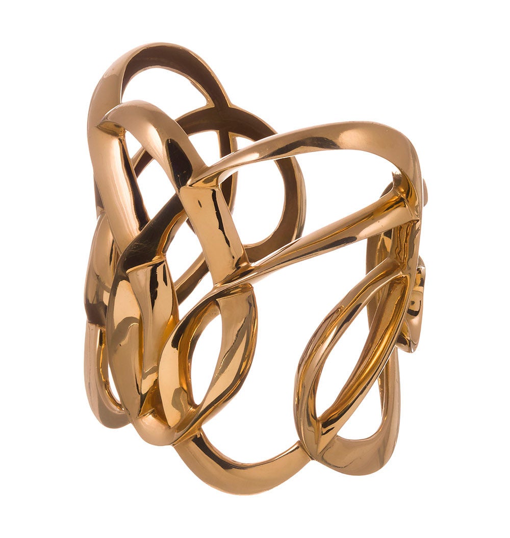 This is an amazing mid-century treasure! Giant and heavy as can be, this piece will delight the fashion-forward and collectors of beautiful objects. Spirals of gold are wrapped around themselves in a semi-random scrolling pattern. The cuff is open