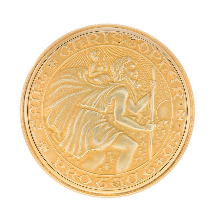 1 3/4 inch in diameter and made of 14k yellow gold, this charming St. Christopher coin opens to reveal a hidden Movado watch. This is a lovely token to bestow upon your favorite trave