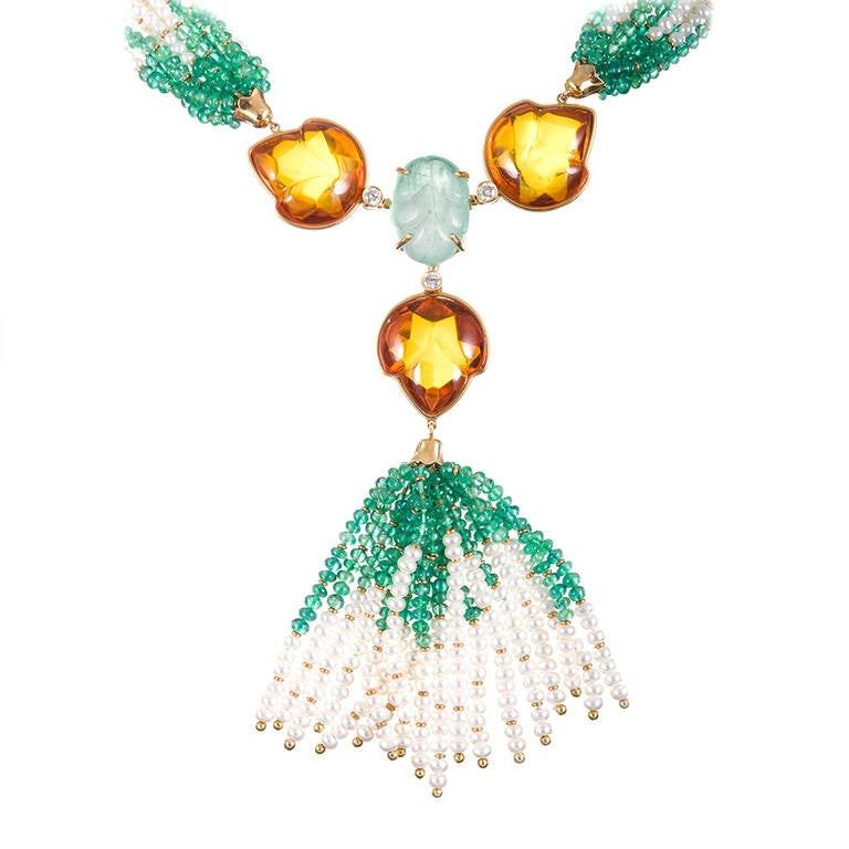 A beautiful organic marriage of carved emerald and amber leaves, emerald and seed pearl beads and just enough diamonds peppered throughout to catch the light at each junction. Oozing feminine charm and textural interest, this piece is certain to