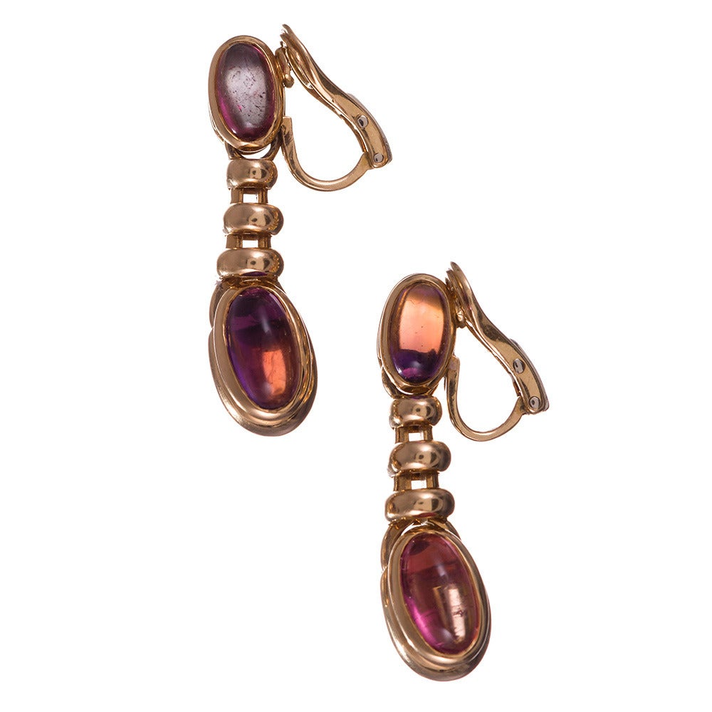 18k yellow gold earrings, the design clearly inspired by Bulgari’s celebrated creations, the opposing tips of the tops and bottoms set with assorted cabochon gemstones. 1.5 inches long and sophisticated for their unique architectural stye and subtle