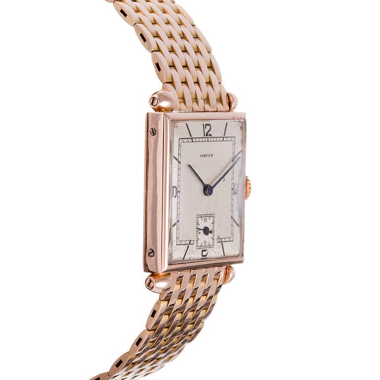 18k rose gold Cartier wristwatch. Manual-wind European Watch and Clock movement with an unrestored dial with subsidiary seconds. Original hands and an incredible original brick bracelet with deployant buckle in mint condition. A full compliment of