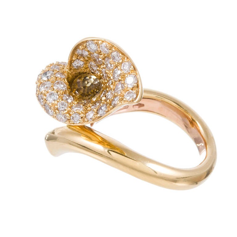 18k yellow gold ring, designed as  a calla lily that wraps around your finger, with 1.57 carats of brilliant round white diamonds lining the inside of the flower and tip of the stem and an .87 carat briolette cut fancy yellow diamond nestled at the