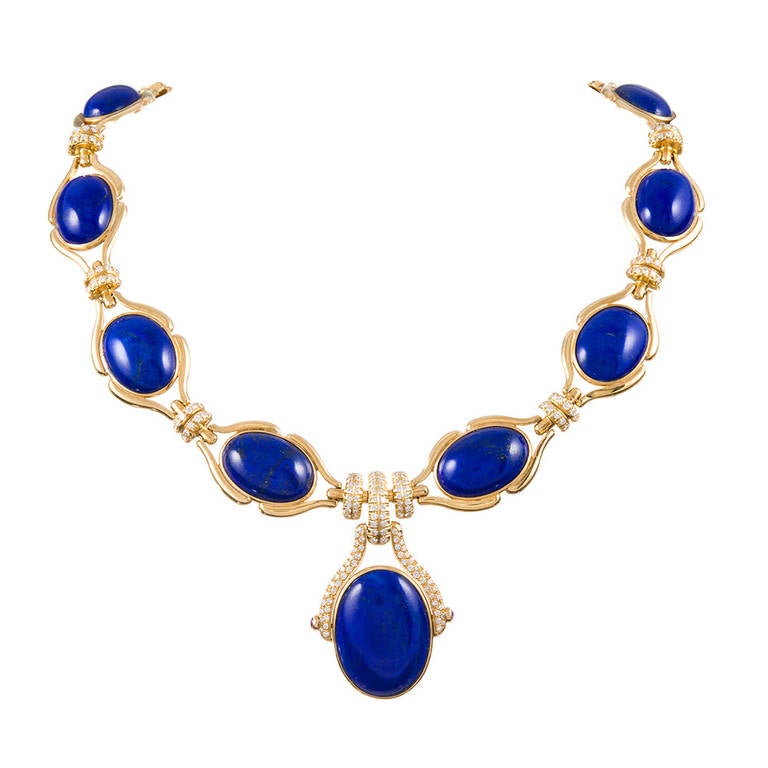 Royal blue cabochon lapis lazuli, each encircled in 18k yellow gold in a stylized bezel and connected by double rows of diamonds and punctuated by a larger lapis drop. This is a gorgeous necklace, with a very sophisticated look. The piece has been
