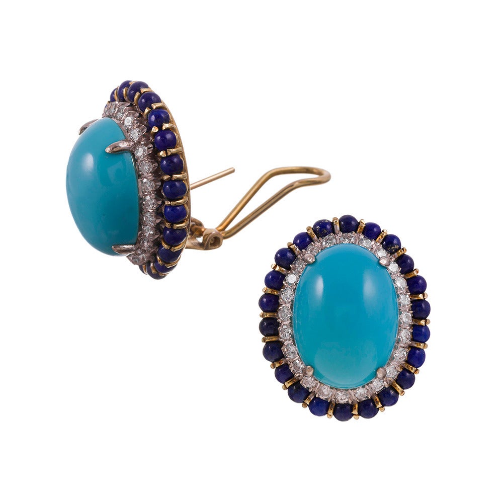 Measuring 1 inch by 7/8 of an inch, this oval-shaped earrings offers a unique combination of gemstones that will enhance any color palette and brighten your smile. 1.44 carats of brilliant round white diamonds frame the turquoise cabochon and the