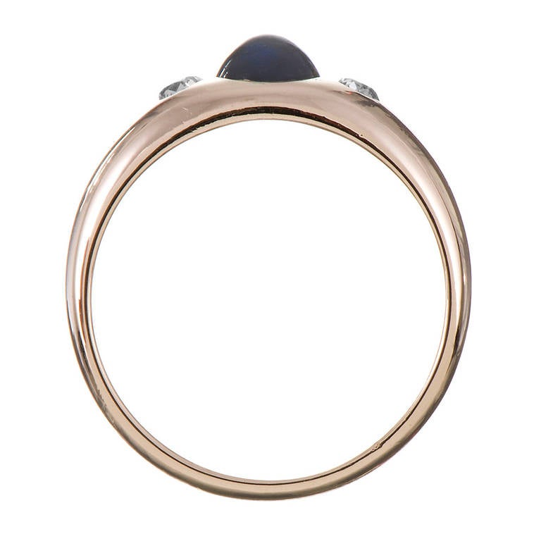 14k yellow gold gypsy style ring, set with a 1.50 carat cabochon sapphire and two diamonds weighing approximately .33 carats combined. This is a great style to stack with other rings and is extremely comfortable on the finger. Made in the US, circa