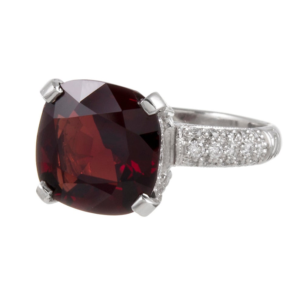 An intense, deep red spinel weighing 6.17 carats, set in a platinum mounting with .70carats of diamonds glittering in the background. Spinel is an uncommon gemstone that is easily recognized by those nitrated in the world of fine jewelry. This ring