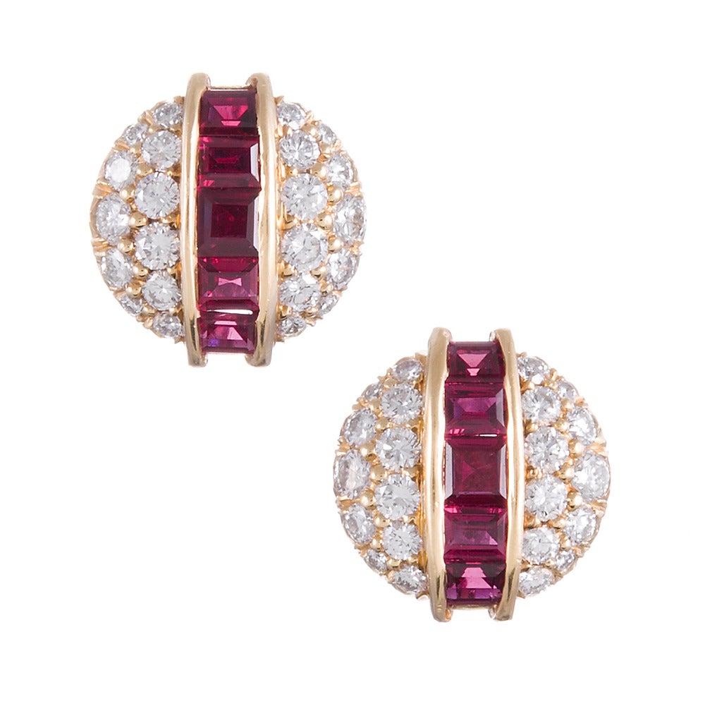 18k yellow gold ring and earrings, a unique design with hints of inspiration from the 1940s retro era, pairing brilliant white diamonds with vibrant red rubies. The ring contains 1 carat of rubies and 2 carats of diamonds. The pierced stud-style