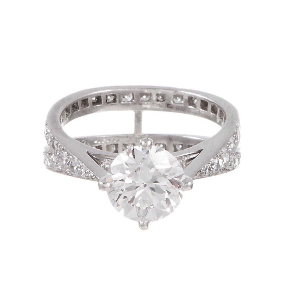 A gorgeous alternative to Tiffany & Co.'s ultra-traditional styles, for the bride who seeks something timeless and classic, yet still a bit different. Set in platinum with a 1.79 carat round brilliant diamond center. The center diamond is GIA-graded