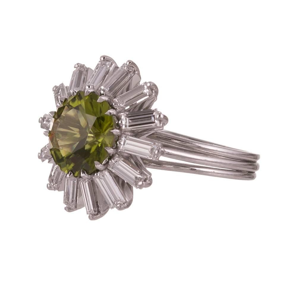  Platinum ballerina ring, a classic mid-century design that is as timeless as a cluster, yet offers an additional layer of interest. The center peridot weighs 2.60 carats and the surrounding frame of baguette diamonds weigh 1.00 carat in total. When