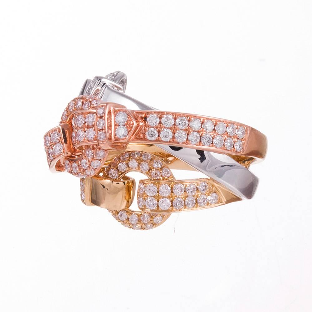 Bands of white-, yellow-, and rose gold, each set with diamonds and decorated with a buckle, are intertwined to create a modern rendition of a theme popular since the 1800s. Queen Victorian had an affinity for buckle jewelry and this motif has