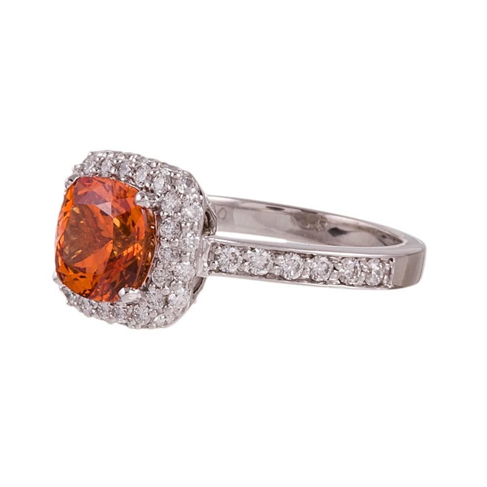 A lively orange garnet bursts from a frame of brilliant white diamonds. This piece would make a lovely engagement ring for the non-traditional bride. Or could liven up an ensemble in nearly any color palette for she who wishes for a special piece
