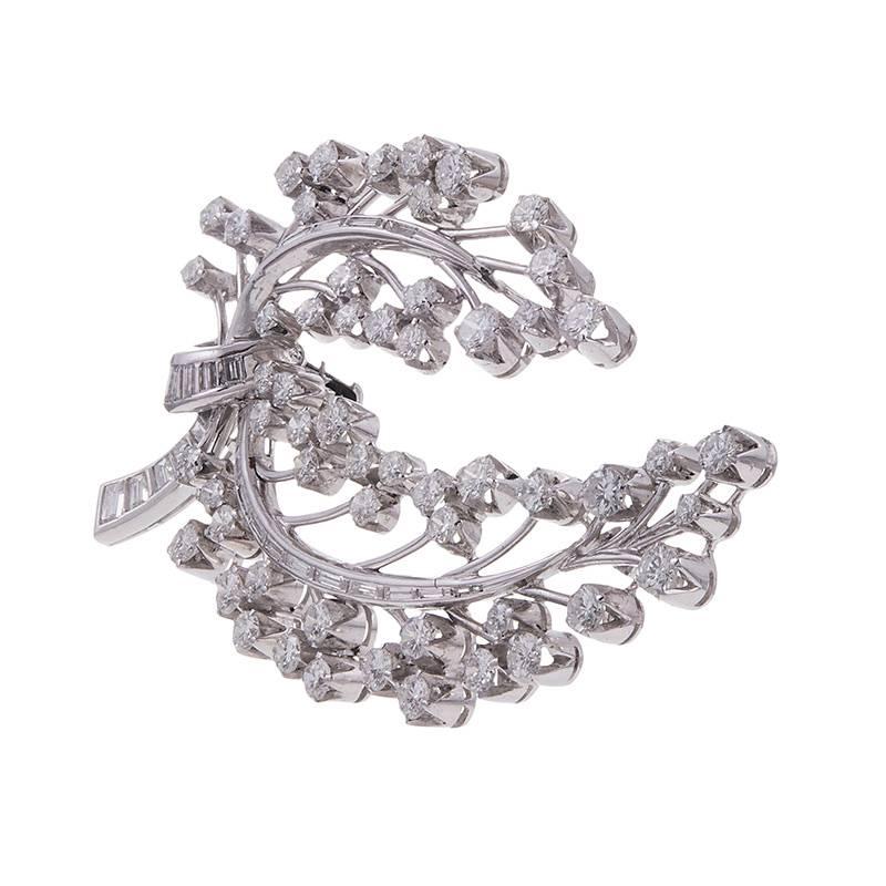 Platinum brooch, a classic theme that will forever endure, set with 4 carats of brilliant round- and 1 carat of baguette diamonds. Substantial distinctly vintage, this piece will make a valued addition to any lady’s jewelry box. 2.5 by 1.5 inches. 