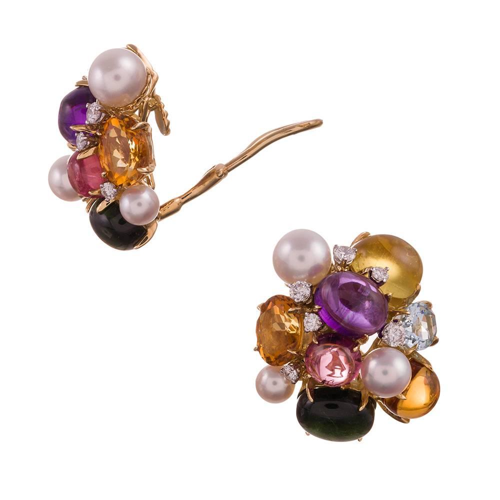 A playful take on classic a cluster design, compliments of iconic American jeweler Seaman Schepps. Multi-colored gemstones, pearls and diamonds- .72 carats in total, are a symbiotic pastel color combination with a backdrop of 18k yellow gold. 1 inch