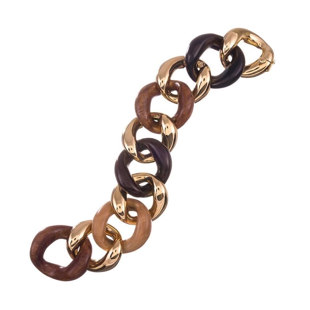 An instant classic, compliments of iconic jewelry designer Seaman Schepps. Carved links of sandalwood, rosewood, ebony and walnut alternate with identical links of 18k yellow gold, epitomizing “organic chic” and truly embracing the classic