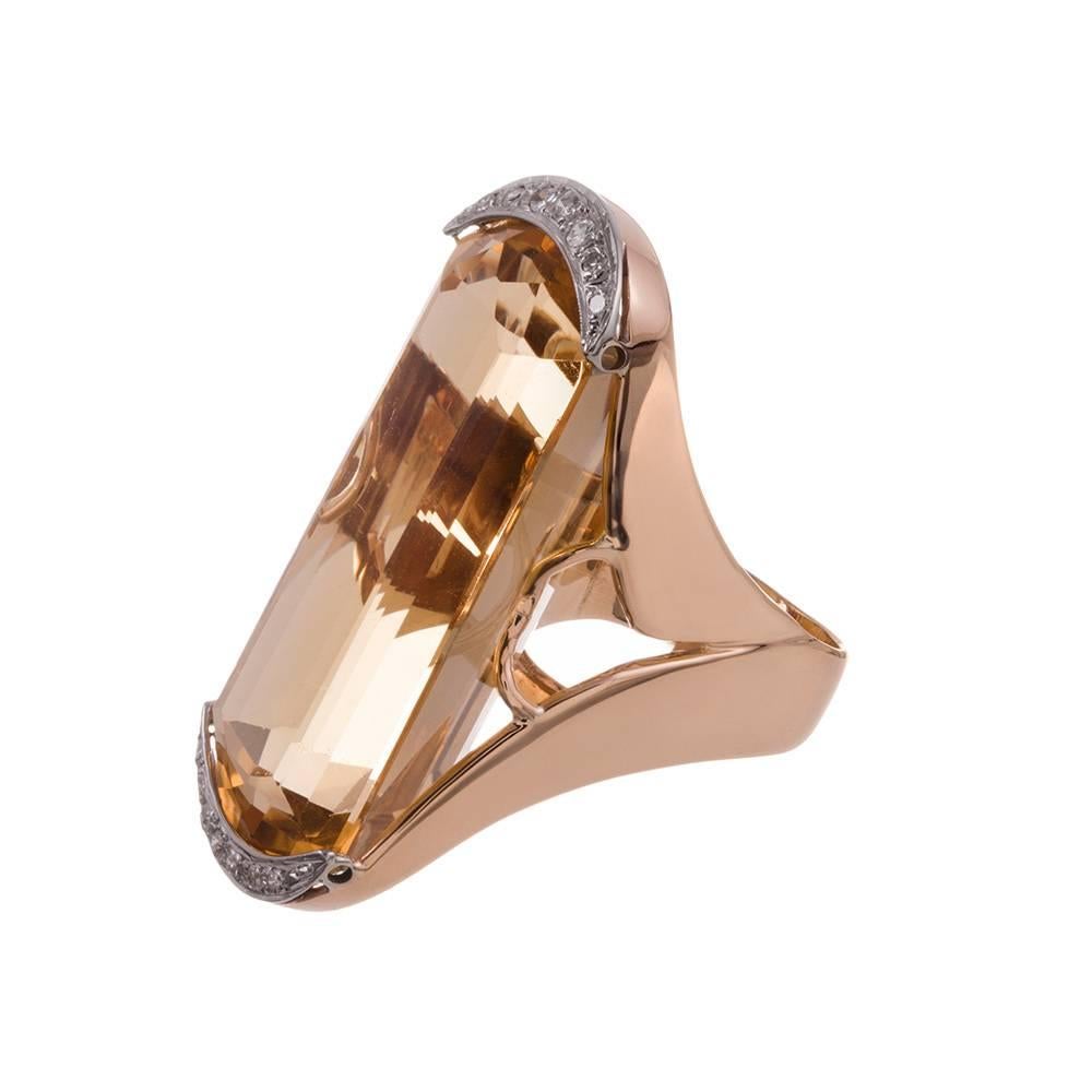 14 karat yellow gold modern ring, displaying an enormous citrine, capped at both ends by brilliant white diamonds. This neutral organic stone is a subtle compliment to nearly any color palette and skin tone. Wear it with everything. The citrine