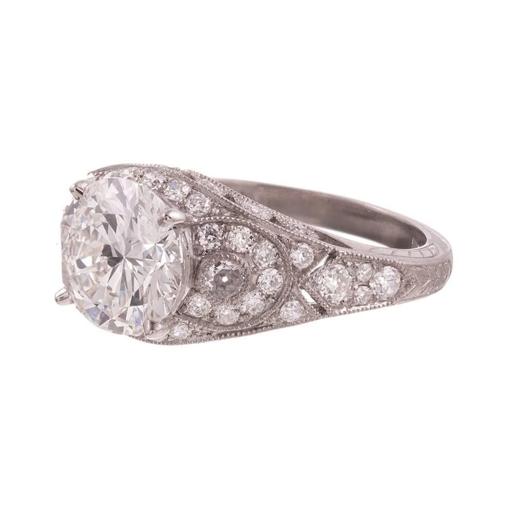 Gorgeous ring, highly decorated and eye-catching from every angle, rendered in platinum and set int eh center with a single round brilliant diamond. The diamond exhibits I color and Si1 clarity. It is complimented by .75 carats of additional accent