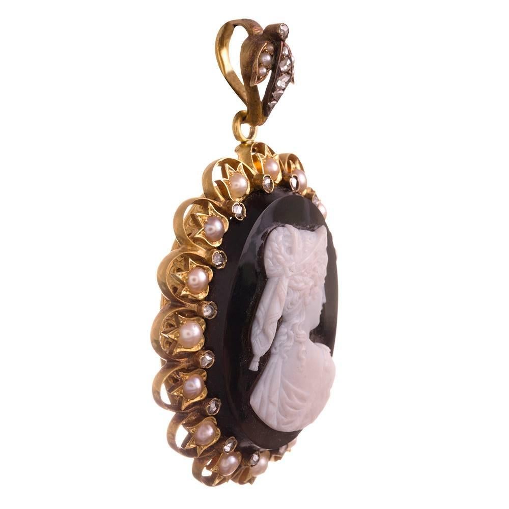Extra fine cameo locket, offering superb detail and an abundance of grand Victorian charm. Look closely to appreciate the scarf tied around the subject’s curled hair and the fabric of her dress draped gracefully on her shoulder. The profile portrait
