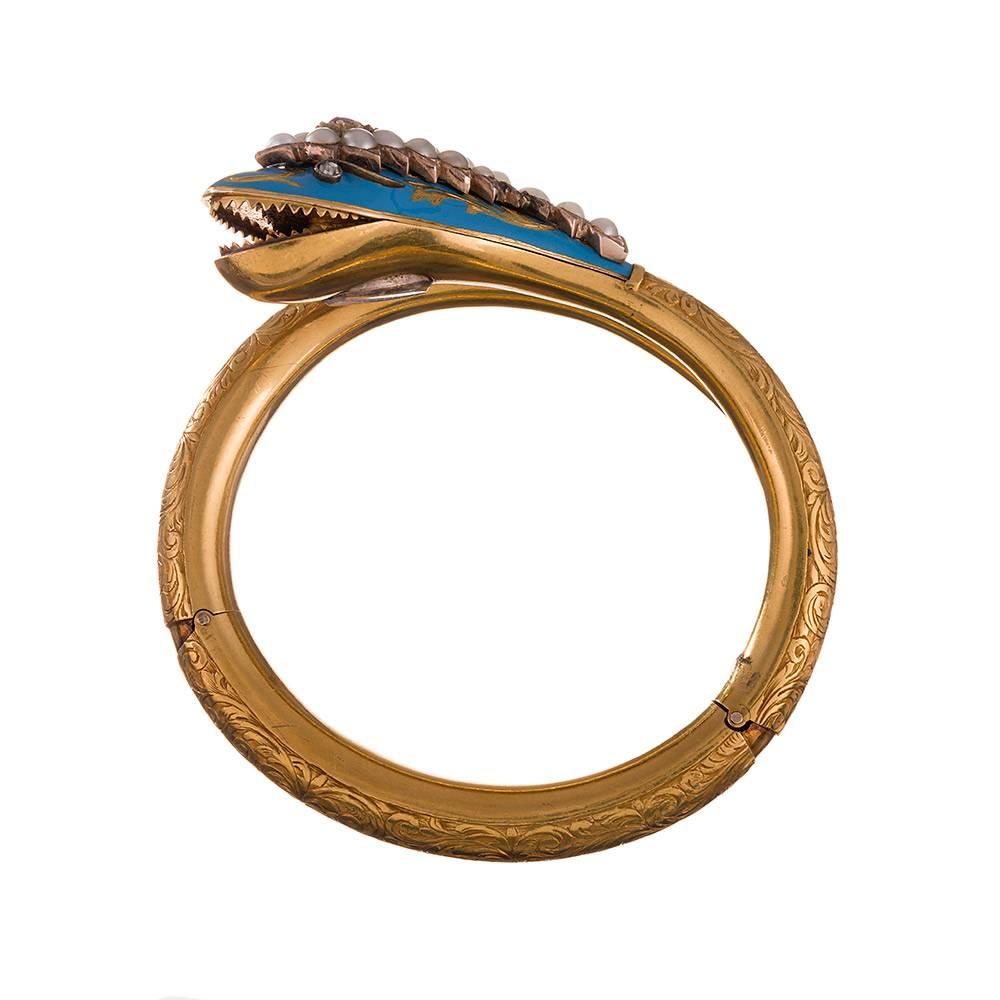 A stunning example, which will delight the antique enthusiast and fashion jewelry collector alike. Immaculately preserved bangle with a double hinge design that opens just widely enough to slide your wrist through. Once inside, the bracelet hugs