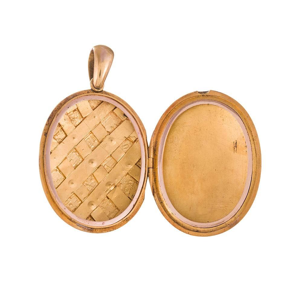 18k yellow gold locket, nice substantial size at 1 3/4 by 1 3/8 (not including the length added by the bale). The front is decorated with a quilted pattern of seed pearls that are reminiscent of a Chanel design. The back is free from any