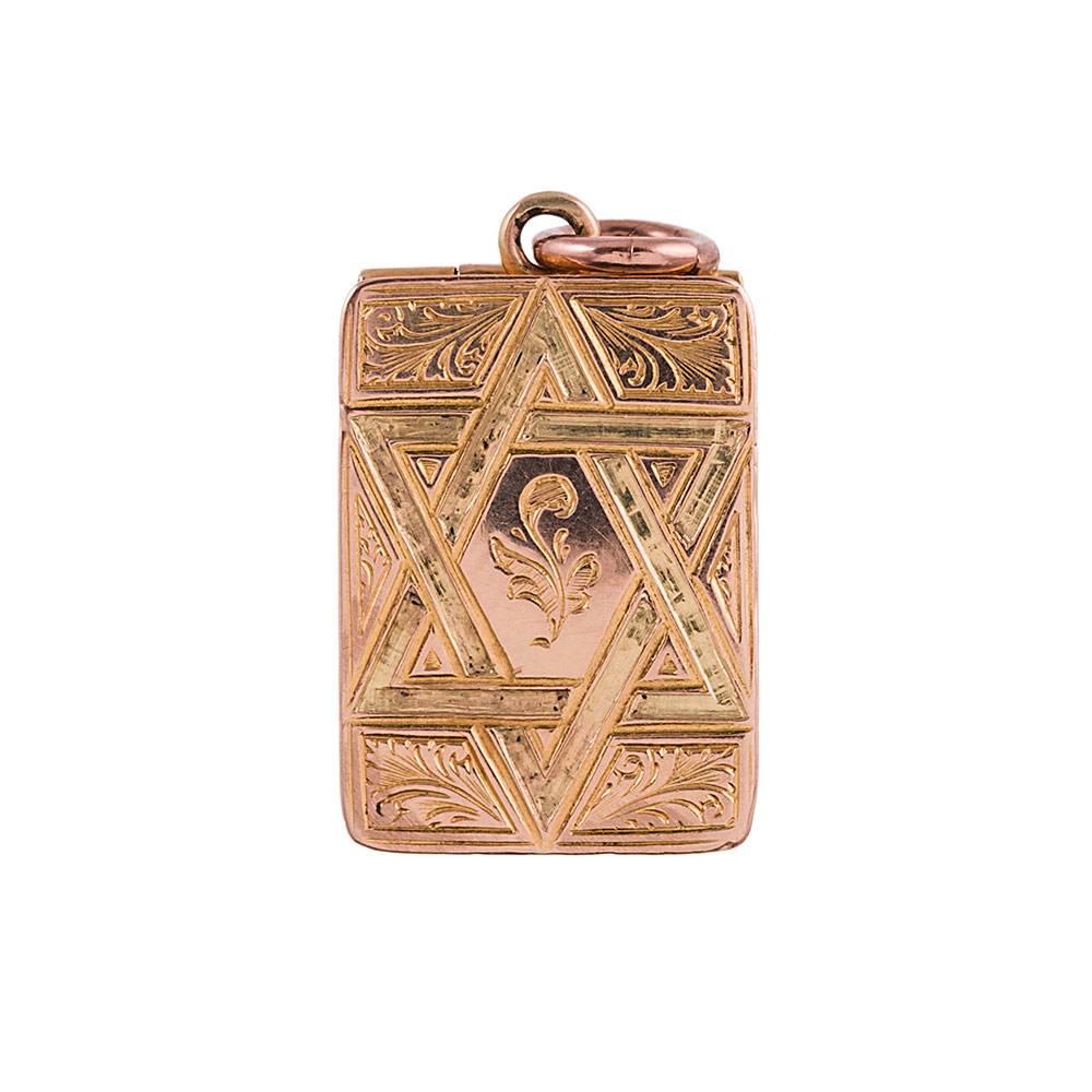 Made of 15 karat yellow gold, this charming little treasure has been skillful hand engraved with a cross on one side and a Star of David on the other. Celebrate your unique heritage and conceal inside some photos of your beloved ancestors. 1 inch by