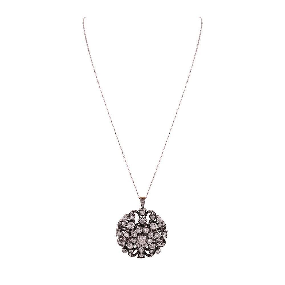 Stunning diamond pendant, a grand Victorian treasure, with approximately 6 carats of old European cut diamonds, assembled in a cluster design and framed by a scalloped border that abstractly mimics a four-leafed clover. The open design looks