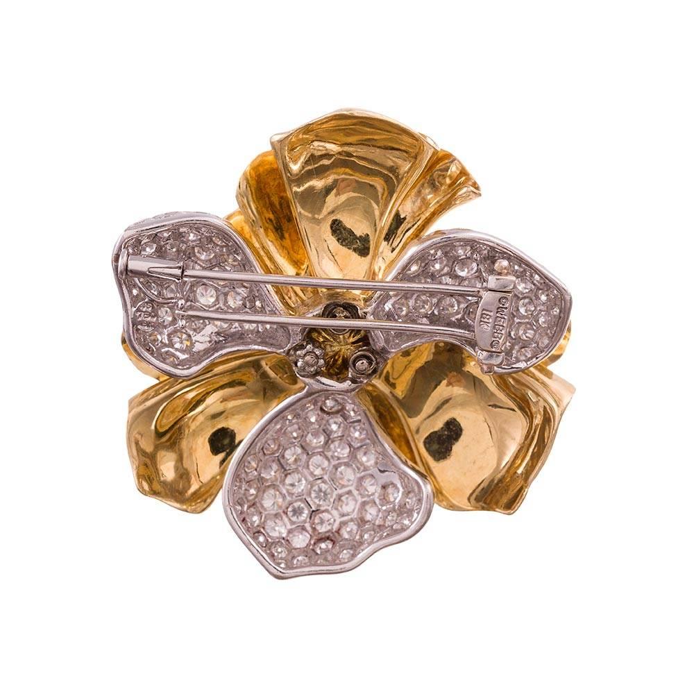 18 karat yellow gold leaves, high polished and arranged in a triple fold alternate with 18 karat white gold leaves that have been set with brilliant diamonds. Look closely to appreciate the honeycomb pattern in which each diamond has been placed. At