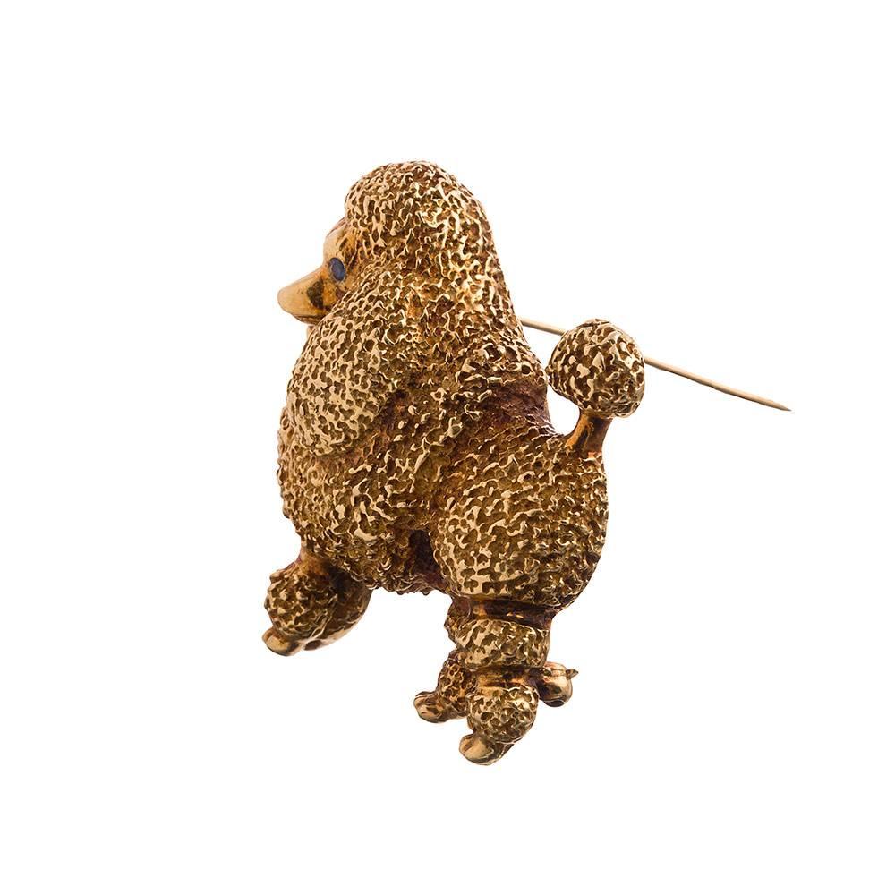 This magnificent poodle has been coifed and is ready to grace your lapel. Standing at attention with sparkling sapphire eyes and the patina to prove she has been sashaying through life since the 1960s. Signed Tiffany1 3/8 by 1 5/8 inches. 