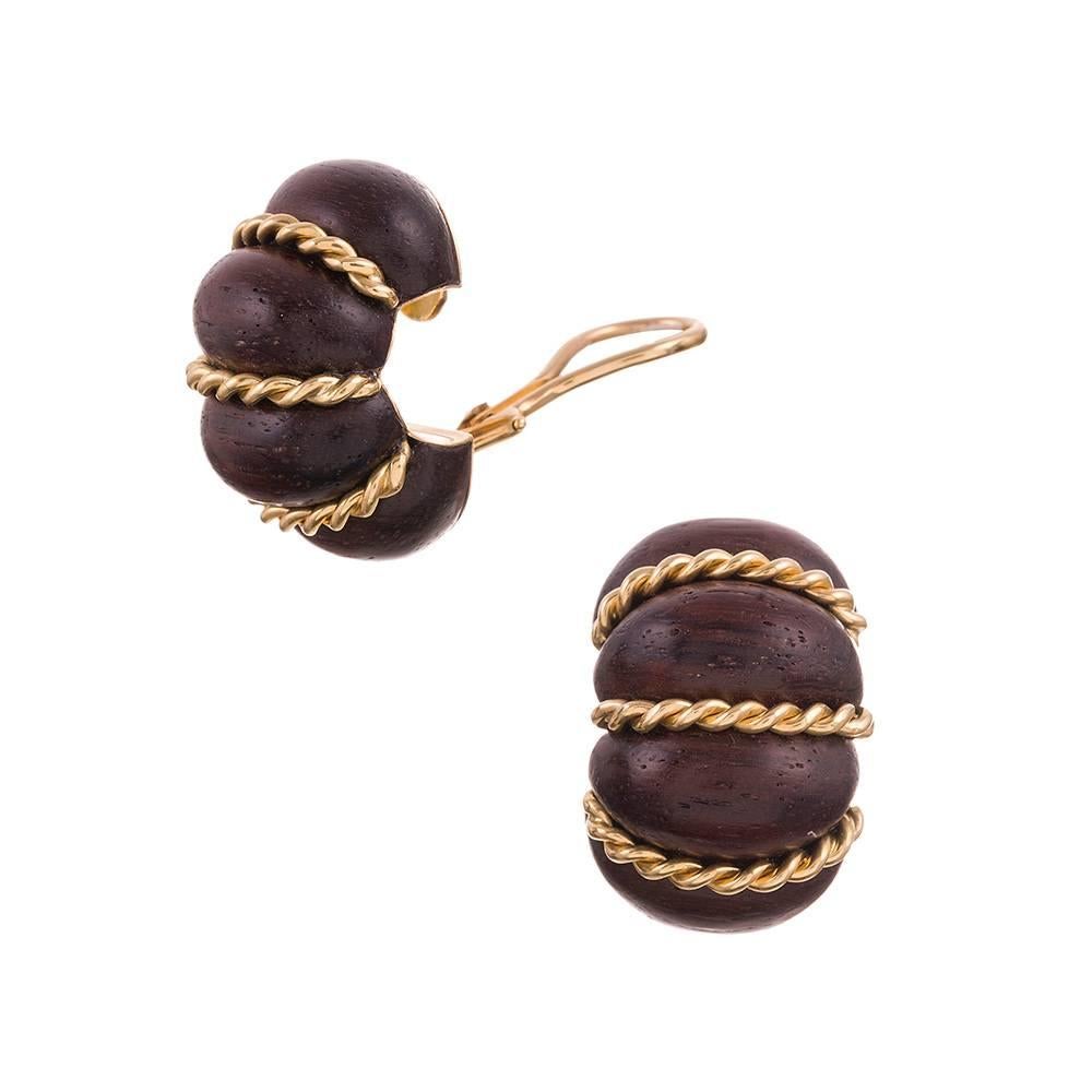 A sophisticated take on a classic hoop design, compliments of iconic American jeweler Seaman Schepps. Sensuously styled sections of rosewood alternate with a twisted rope design, symbiotically creating a sculpture that resembles a shrimp. They