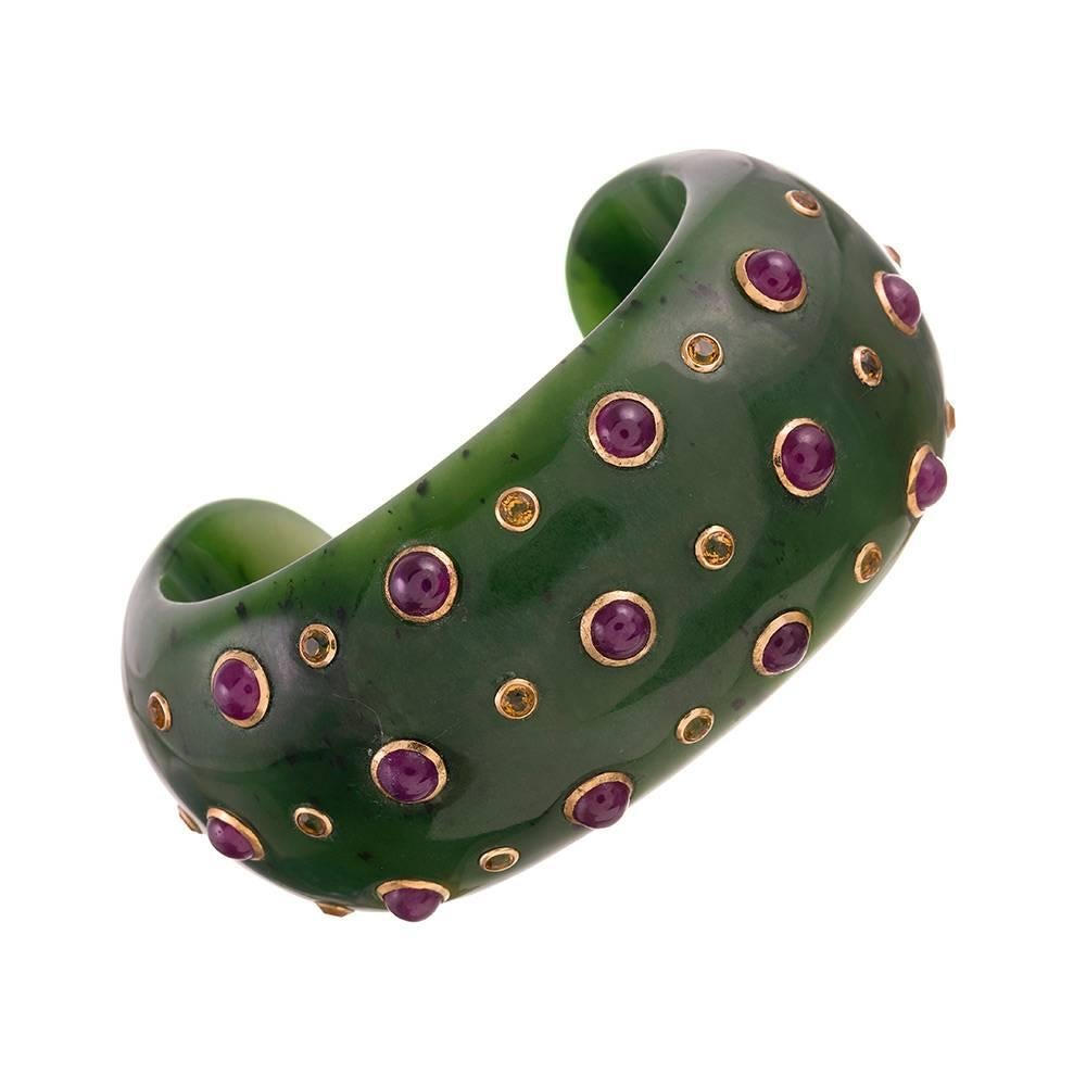 “Organic chic” cuff and matching earrings made of carved jade and decorated with bezel-set cabochon rubies and faceted citrines. The stones are set in 18 karat yellow gold. 

Trianon is the sister company to esteemed American jeweler Seaman