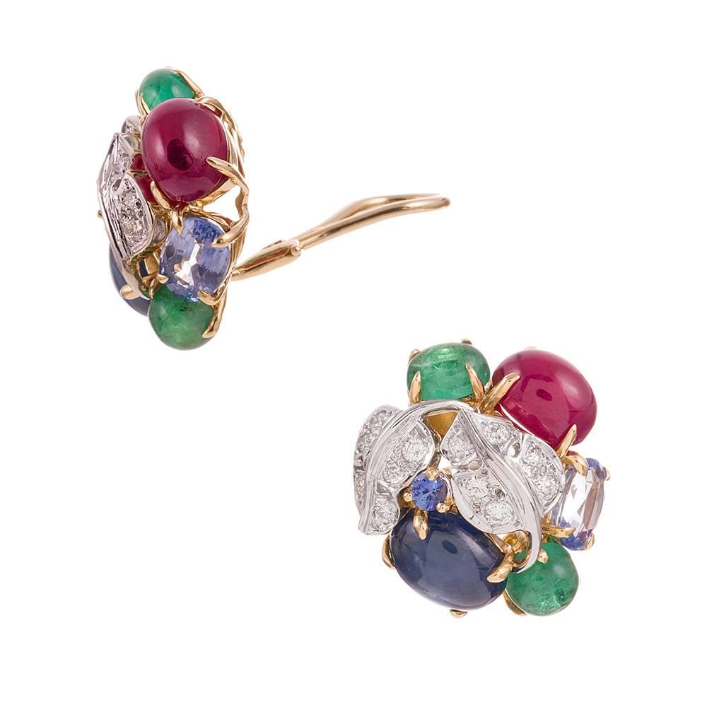 A sophisticated and glamorous design, reminiscent of the art deco “Tutti Frutti” collection popularized by Cartier in the 1930s, but this pair is compliments of iconic American jeweler Seaman Schepps. Cabochons of emerald, ruby and sapphire are