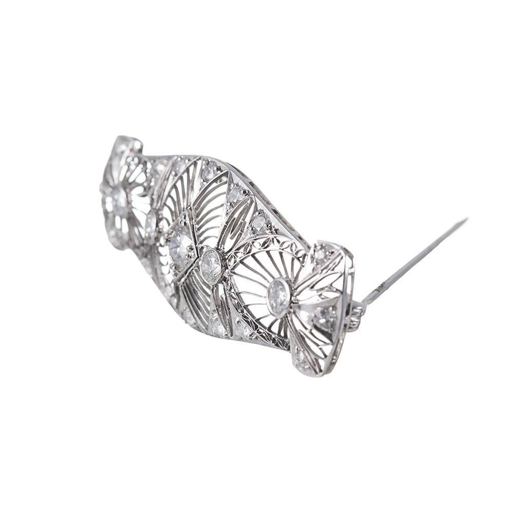 Gorgeous open architecture and platinum wirework highlights 2.75 carats of brilliant round diamonds on this impressive brooch. 2.5 by 1 inches. This piece is stunning on a backdrop of luxurious fabric. 
