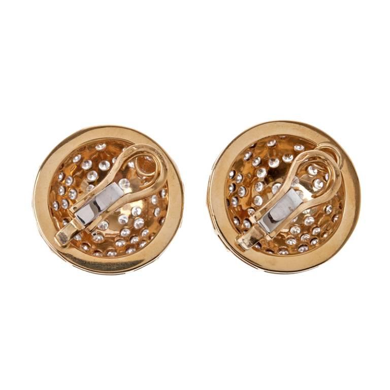 Designed as a striking combination of sparkle and undulating yellow gold pronounced lines, these earrings burst with glamour and style. Measuring an inch in diameter, these clip-on earrings dazzle with 200 diamonds weighing over 7 carats.