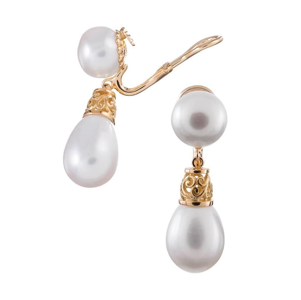 Measuring 1 1/3 inches and displaying two lovely pairs of lustrous freshwater pearls capped with carved gold end pieces. Part of the “Canton” collection, compliments of iconic American jeweler Seaman Schepps. Mounted in 18 karat yellow gold.